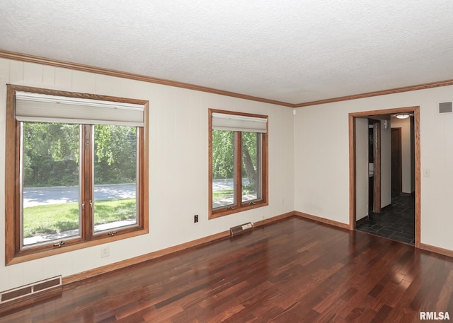 3 Wildwood Trl, Bettendorf, IA 52722 - spare room with dark wood-style floors, plenty of natural light, a textured ceiling, ornamental molding, and baseboards