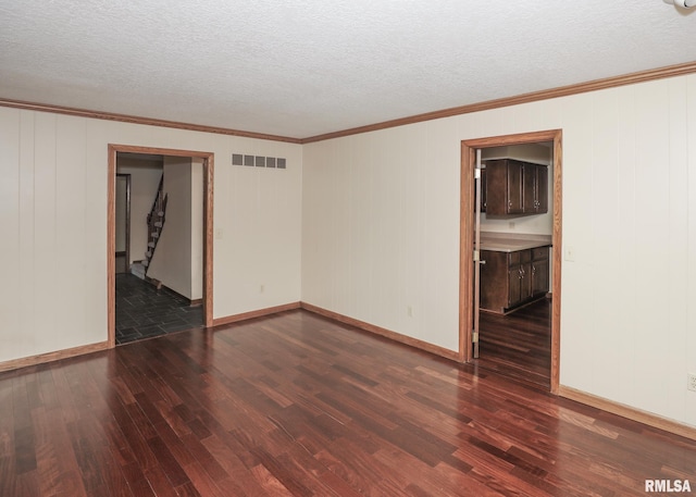 3 Wildwood Trl, Bettendorf, IA 52722 - empty room with dark wood finished floors, ornamental molding, a textured ceiling, and baseboards