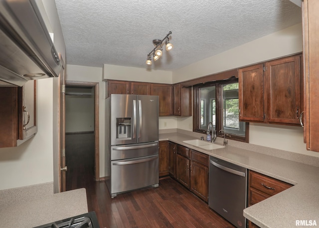 3 Wildwood Trl, Bettendorf, IA 52722 - kitchen with stainless steel appliances, a sink, dark wood-type flooring, light countertops, and a textured ceiling