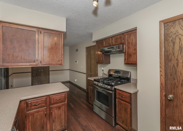 3 Wildwood Trl, Bettendorf, IA 52722 - kitchen featuring stainless steel gas stove, under cabinet range hood, dark wood finished floors, light countertops, and a textured ceiling