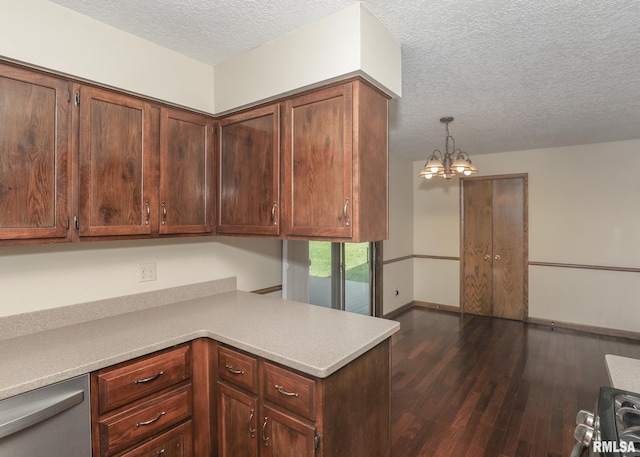 3 Wildwood Trl, Bettendorf, IA 52722 - kitchen with a textured ceiling, dark wood-style floors, light countertops, stainless steel dishwasher, and a chandelier