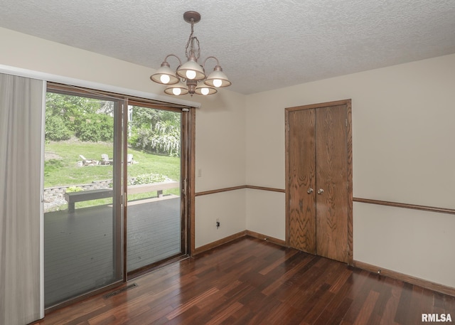 3 Wildwood Trl, Bettendorf, IA 52722 - empty room featuring a chandelier, dark wood-style floors, baseboards, and a textured ceiling