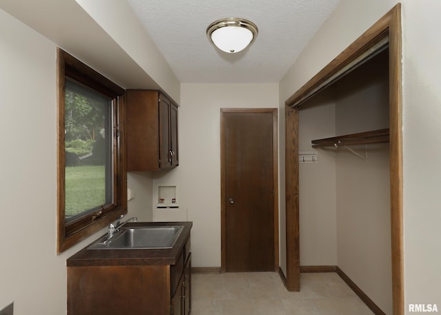 3 Wildwood Trl, Bettendorf, IA 52722 - washroom with washer hookup, cabinet space, baseboards, light tile patterned floors, and a textured ceiling