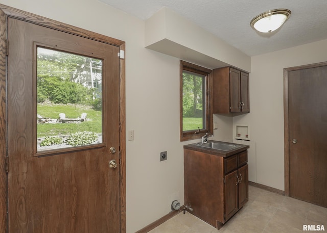 3 Wildwood Trl, Bettendorf, IA 52722 - washroom with electric dryer hookup, washer hookup, cabinet space, baseboards, and light tile patterned flooring