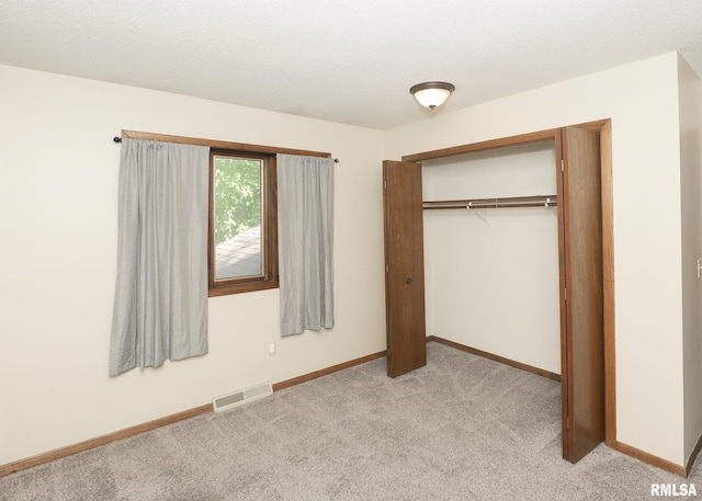 3 Wildwood Trl, Bettendorf, IA 52722 - unfurnished bedroom featuring light colored carpet, a closet, and baseboards