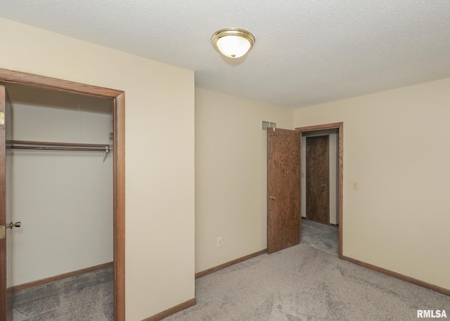 3 Wildwood Trl, Bettendorf, IA 52722 - unfurnished bedroom with carpet flooring, a closet, baseboards, and a textured ceiling