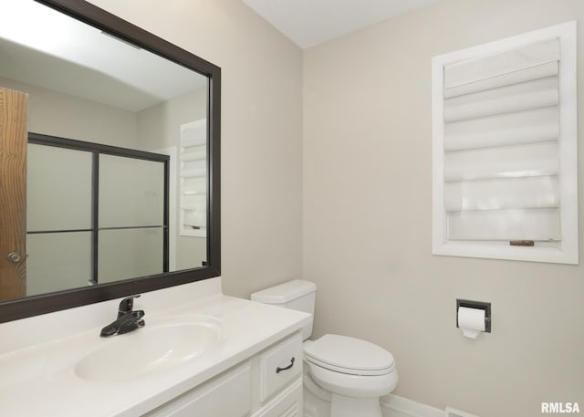 3 Wildwood Trl, Bettendorf, IA 52722 - bathroom with vanity, toilet, a shower with shower door, and baseboards