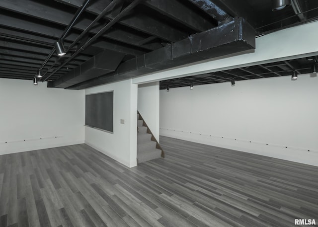 3 Wildwood Trl, Bettendorf, IA 52722 - finished below grade area with stairs, wood finished floors, and baseboards