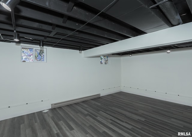 3 Wildwood Trl, Bettendorf, IA 52722 - below grade area featuring dark wood-style floors and a baseboard radiator