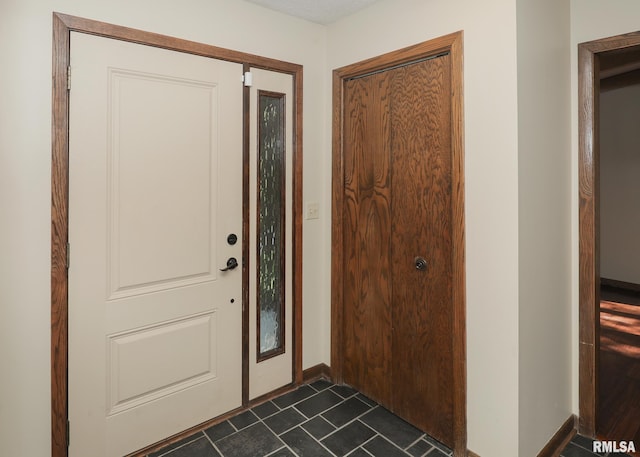 3 Wildwood Trl, Bettendorf, IA 52722 - foyer featuring baseboards and dark tile patterned floors