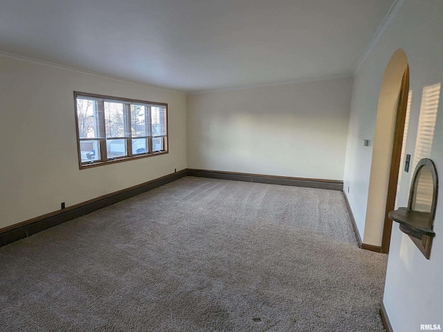 1726 9th St, Moline, IL 61265 - spare room with crown molding, carpet floors, baseboards, and arched walkways