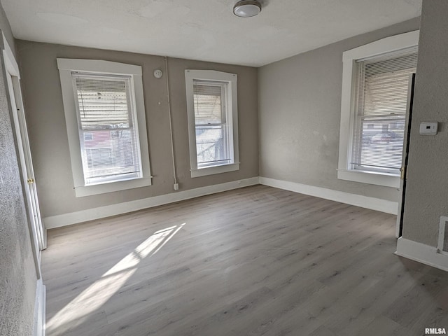 832 W 8th St, Davenport, IA 52803 - spare room with plenty of natural light, wood finished floors, and baseboards