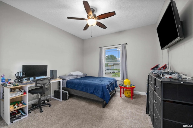 510 W Pinehurst Dr, Eldridge, IA 52748 - carpeted bedroom featuring a textured ceiling, an office area, baseboards, and a ceiling fan
