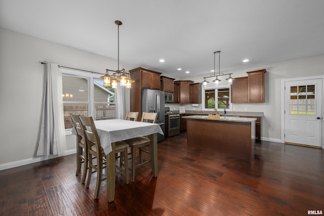 510 W Pinehurst Dr, Eldridge, IA 52748 - dining space with dark wood-style floors, baseboards, recessed lighting, and a chandelier