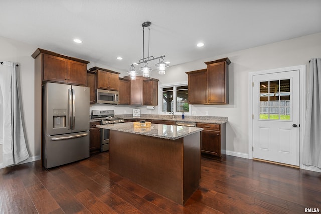 510 W Pinehurst Dr, Eldridge, IA 52748 - kitchen featuring appliances with stainless steel finishes, a sink, light stone countertops, dark wood-style floors, and recessed lighting