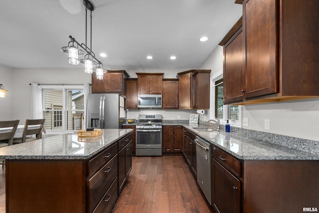 510 W Pinehurst Dr, Eldridge, IA 52748 - kitchen with stainless steel appliances, a sink, dark wood-style floors, recessed lighting, and stone countertops