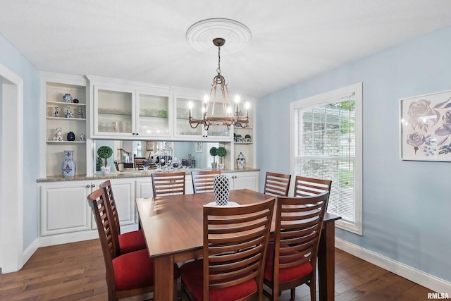 2312 Windsor Dr, Davenport, IA 52807 - dining room with dark wood-type flooring, a chandelier, and baseboards