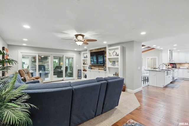 2312 Windsor Dr, Davenport, IA 52807 - living area featuring a ceiling fan, recessed lighting, light wood-style floors, and baseboards