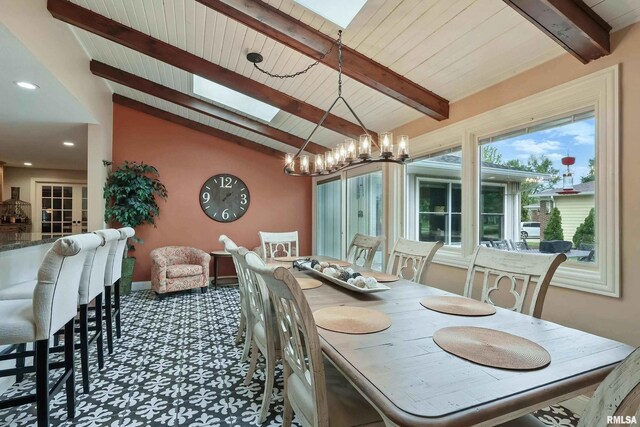 2312 Windsor Dr, Davenport, IA 52807 - dining room with a skylight, a chandelier, wooden ceiling, recessed lighting, and baseboards