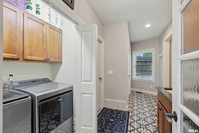 2312 Windsor Dr, Davenport, IA 52807 - laundry room with washer and clothes dryer, baseboards, recessed lighting, and cabinet space