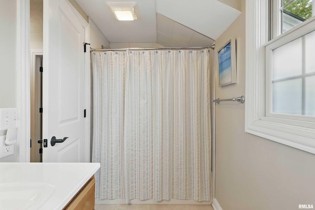 2312 Windsor Dr, Davenport, IA 52807 - full bathroom featuring vanity, curtained shower, vaulted ceiling, and tile patterned flooring