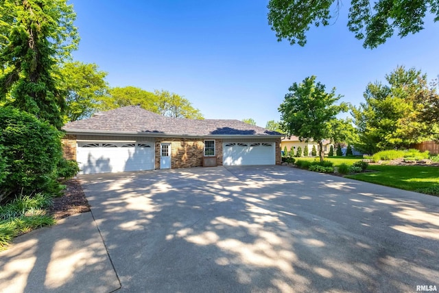 2312 Windsor Dr, Davenport, IA 52807 - view of front of home featuring driveway, an attached garage, and brick siding