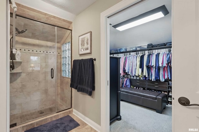 2312 Windsor Dr, Davenport, IA 52807 - bathroom with baseboards, a stall shower, and a walk in closet