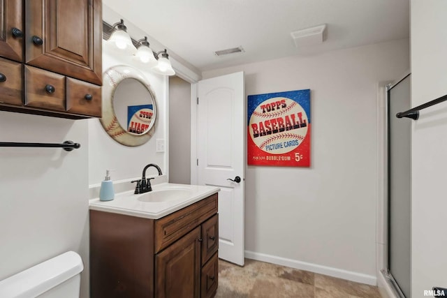 2312 Windsor Dr, Davenport, IA 52807 - bathroom with vanity, toilet, and a shower with shower door