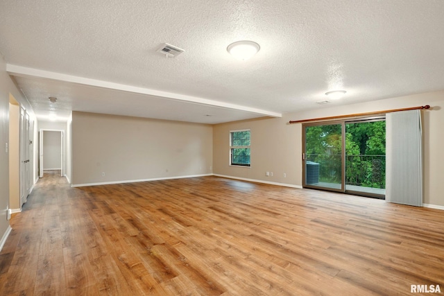 1360 Kimberly Ridge Rd Unit 306, Bettendorf, IA 52722 - unfurnished room featuring a textured ceiling, light wood-type flooring, and baseboards