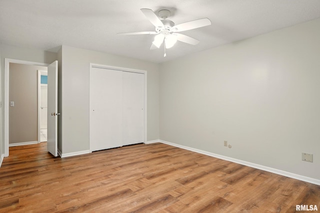 1360 Kimberly Ridge Rd Unit 306, Bettendorf, IA 52722 - unfurnished bedroom with light wood-style floors, baseboards, and a closet