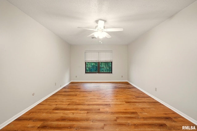 1360 Kimberly Ridge Rd Unit 306, Bettendorf, IA 52722 - spare room with ceiling fan, light wood finished floors, and baseboards