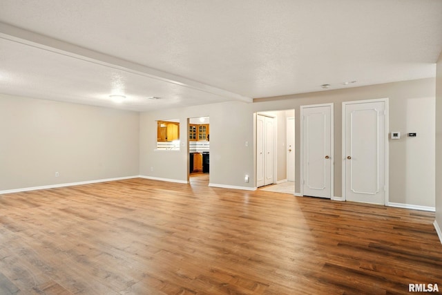 1360 Kimberly Ridge Rd Unit 306, Bettendorf, IA 52722 - unfurnished living room with light wood-style floors and baseboards