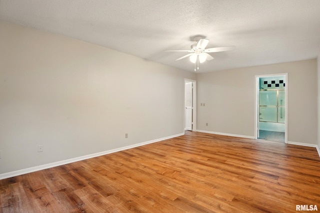 1360 Kimberly Ridge Rd Unit 306, Bettendorf, IA 52722 - spare room with a ceiling fan, light wood-style flooring, and baseboards