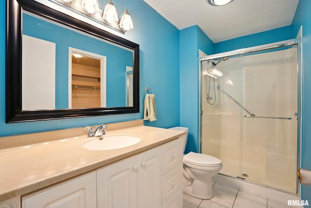 1360 Kimberly Ridge Rd Unit 306, Bettendorf, IA 52722 - bathroom with a shower stall, marble finish floors, toilet, and vanity