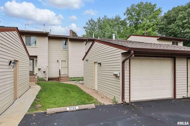 3765 Cedarwood Ct, Bettendorf, IA 52722 - rear view of house featuring entry steps, roof with shingles, a chimney, and a yard