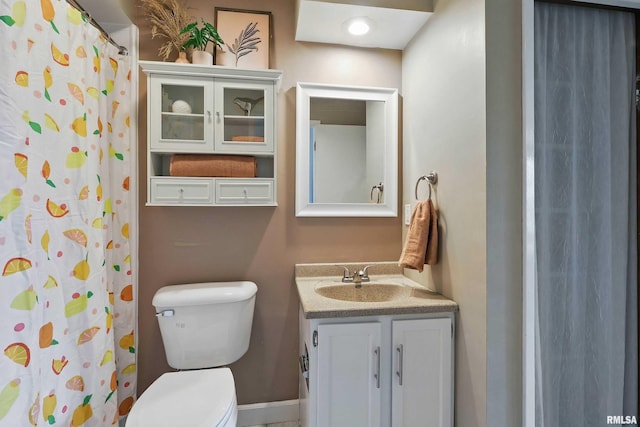 3765 Cedarwood Ct, Bettendorf, IA 52722 - bathroom with toilet, vanity, a shower with curtain, and baseboards