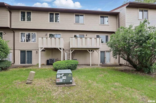 3765 Cedarwood Ct, Bettendorf, IA 52722 - back of house featuring central AC, a lawn, and brick siding