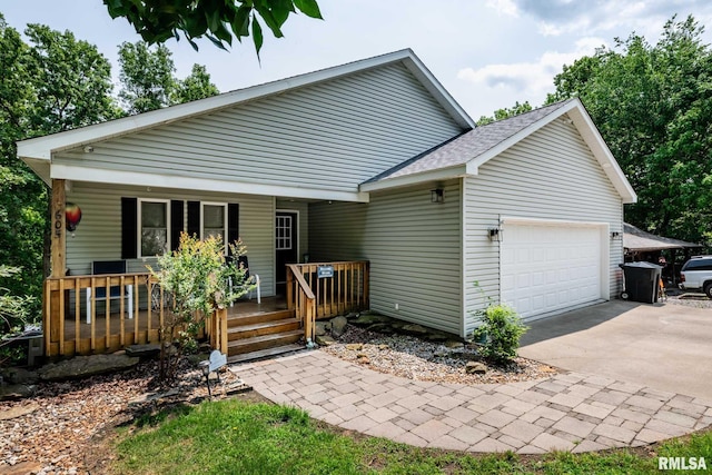 605 Lakeshore Dr S, Goreville, IL 62939 - rear view of property featuring a porch, an attached garage, concrete driveway, and roof with shingles