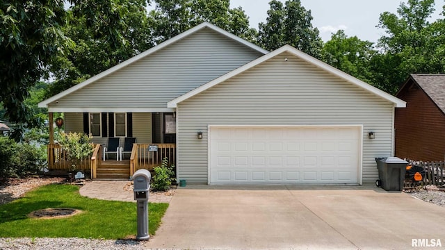 605 Lakeshore Dr S, Goreville, IL 62939 - view of front facade with a porch, an attached garage, and driveway