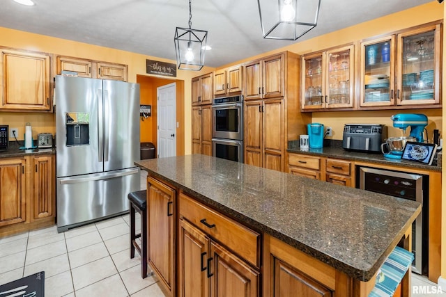 605 Lakeshore Dr S, Goreville, IL 62939 - kitchen featuring stainless steel appliances, beverage cooler, brown cabinetry, glass insert cabinets, and light tile patterned flooring