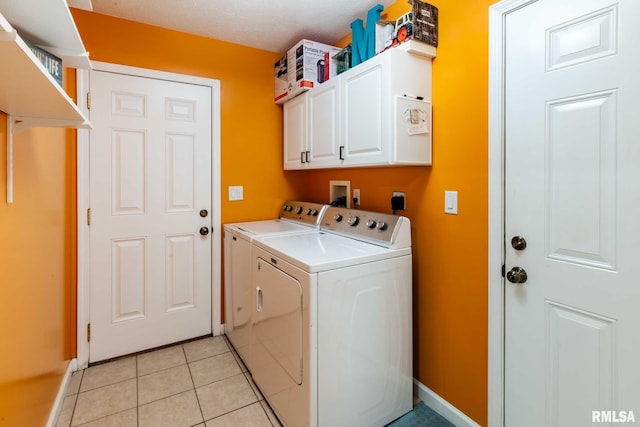 605 Lakeshore Dr S, Goreville, IL 62939 - laundry room featuring washer and clothes dryer, cabinet space, and light tile patterned floors