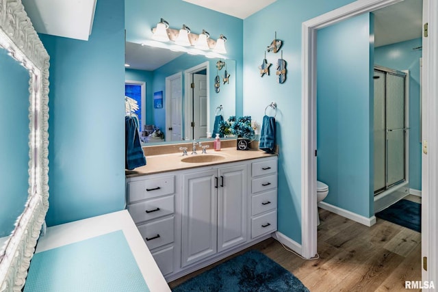 605 Lakeshore Dr S, Goreville, IL 62939 - bathroom with wood finished floors, a shower stall, and vanity