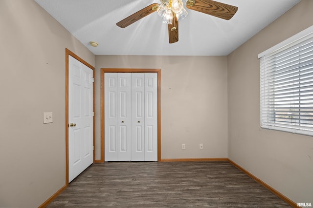 3814 Creek Hill Dr, Bettendorf, IA 52722 - unfurnished bedroom with a closet, dark wood-style floors, baseboards, and a ceiling fan