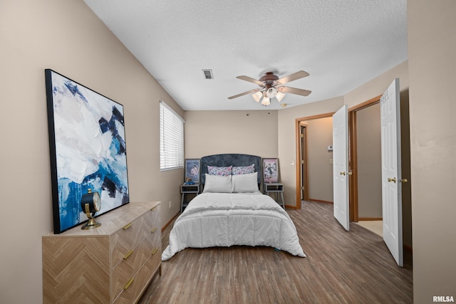 3814 Creek Hill Dr, Bettendorf, IA 52722 - bedroom with wood finished floors, baseboards, a textured ceiling, and ceiling fan