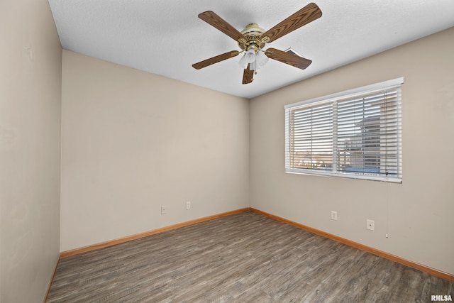3814 Creek Hill Dr, Bettendorf, IA 52722 - spare room with wood finished floors, baseboards, a ceiling fan, and a textured ceiling
