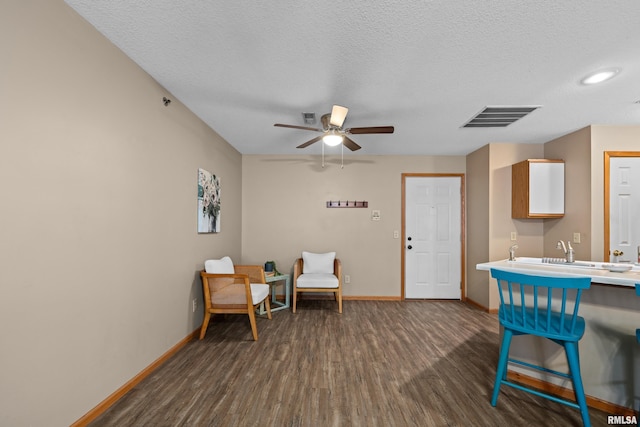 3814 Creek Hill Dr, Bettendorf, IA 52722 - living area with dark wood-style floors, baseboards, a ceiling fan, and a textured ceiling