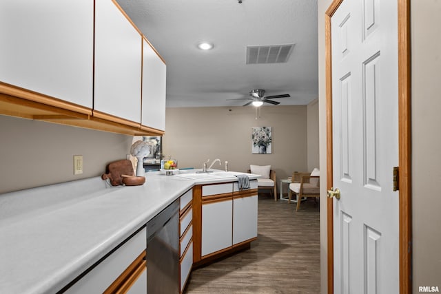 3814 Creek Hill Dr, Bettendorf, IA 52722 - kitchen featuring stainless steel dishwasher, white cabinets, wood finished floors, light countertops, and recessed lighting