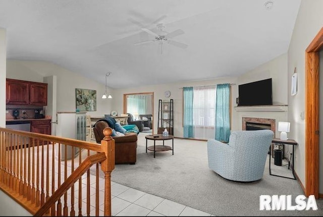 2521 W 63rd St, Davenport, IA 52806 - living room with light colored carpet, vaulted ceiling, a ceiling fan, a fireplace, and light tile patterned floors