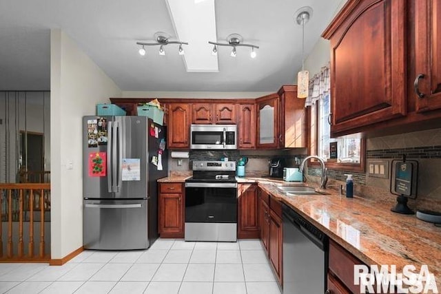 2521 W 63rd St, Davenport, IA 52806 - kitchen featuring appliances with stainless steel finishes, a sink, backsplash, and light stone countertops