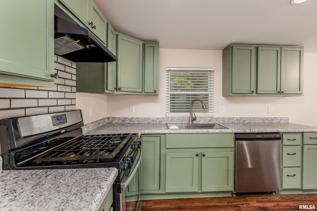 1104 E Lindell St, West Frankfort, IL 62896 - kitchen with stainless steel appliances, a sink, green cabinetry, and under cabinet range hood
